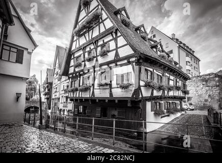 Half-timbered Crooked House or Hotel Schiefes Haus in black and white, Ulm, Germany. It is tourist attraction of Ulm located in old Fisherman`s Quarte